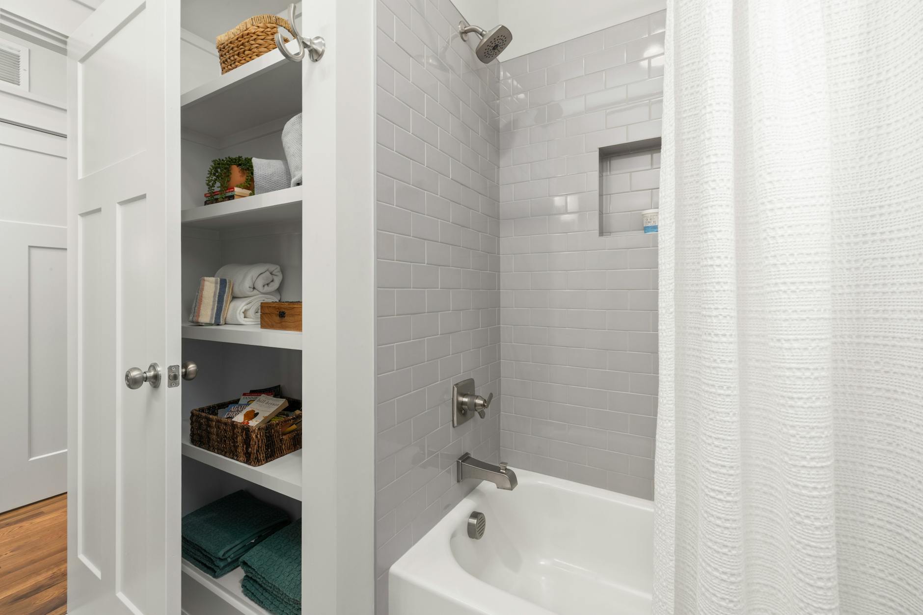 Bathroom storage with both open shelves and closed cabinets