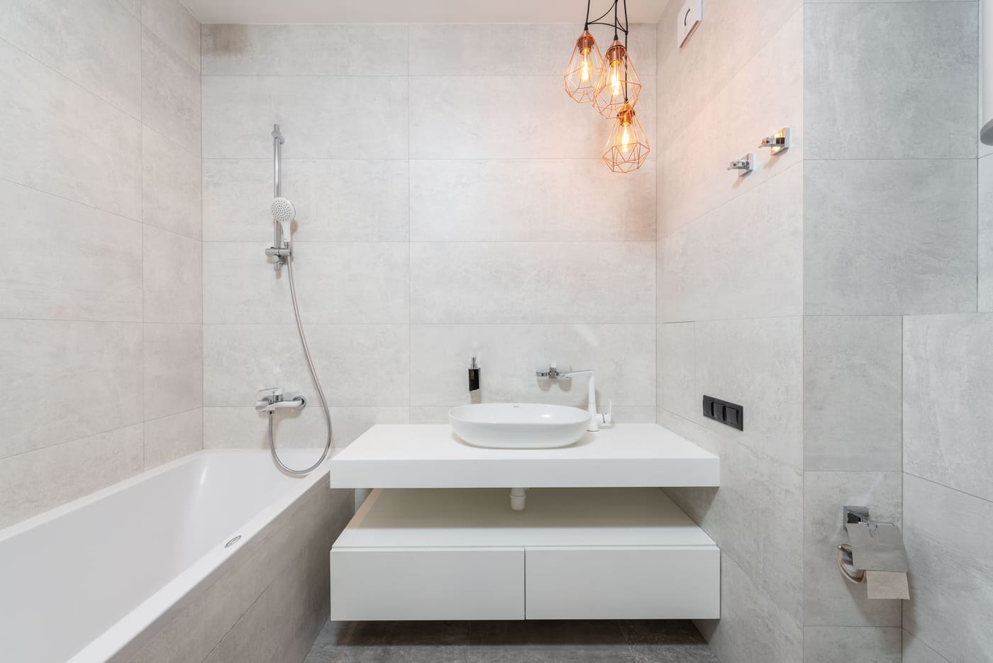 Bright bathroom with a wall-hung white vanity and marble tiles