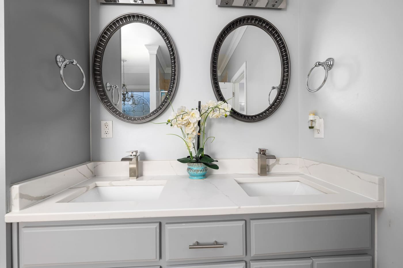 Double-sink vanity with two mirrors and a mostly clear counter