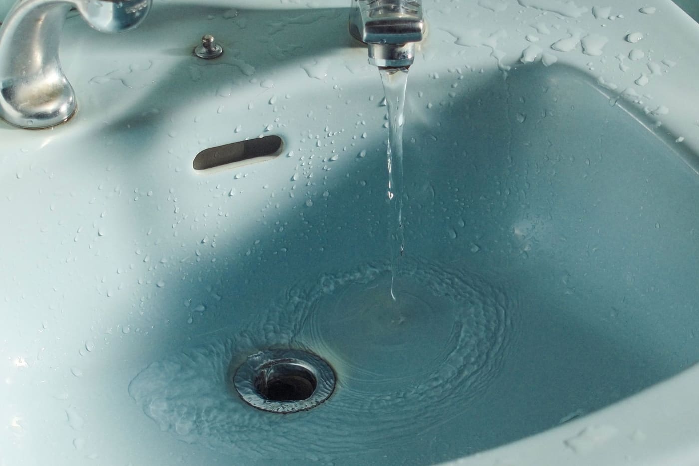 Water flowing from a faucet into a bathroom sink