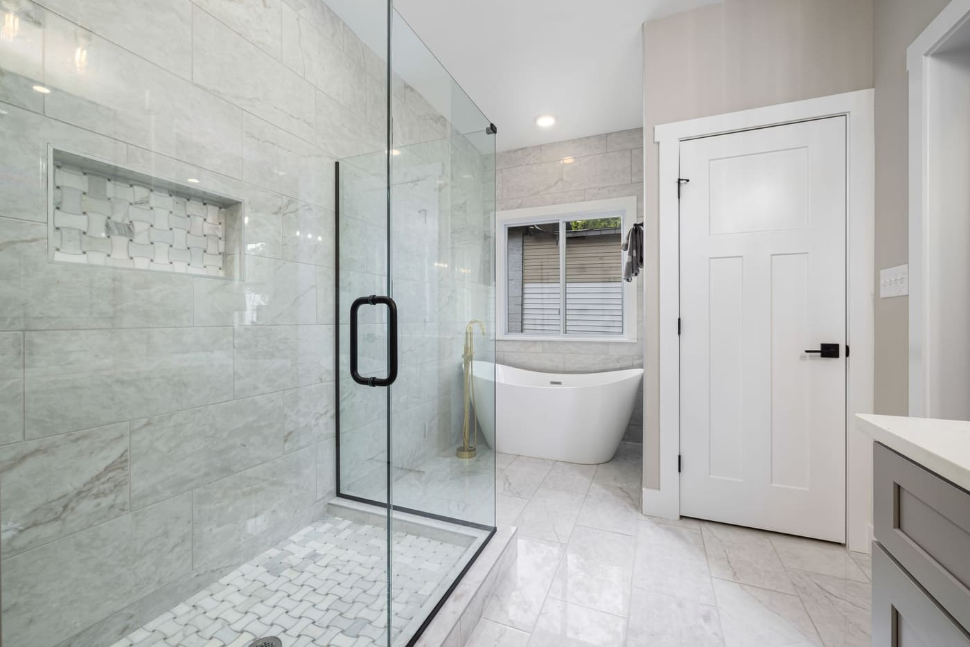 Glass shower enclosure in a bright modern bathroom