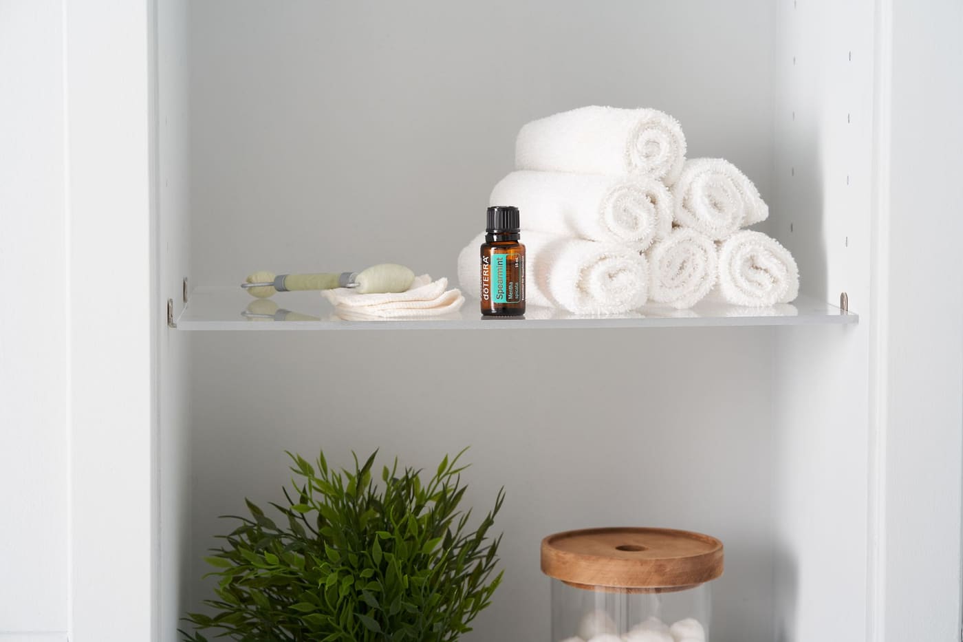 Neatly folded white towels on a shelf