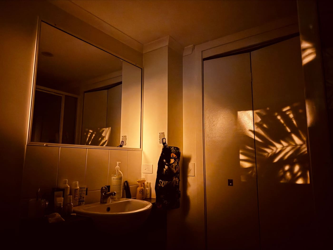 Bathroom lit by a low, warm light at night